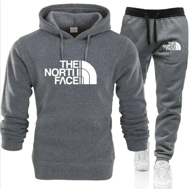 UnWritten Style hoodie and jogger set in charcoal gray fleece, with white The North Face logos and black waistband.