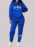 UnWritten Style tracksuit in cobalt blue polyester, featuring a drawstring hoodie and joggers with white Los Angeles 1991 lettering.