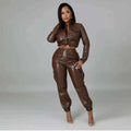Faux leather two-piece set in chocolate brown, with a cropped tie-front jacket and cuffed jogger pants, UnWritten Style.