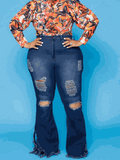 Distressed denim jeans in dark blue with ripped thighs, flared legs and frayed hems, UnWritten Style high-rise fit.