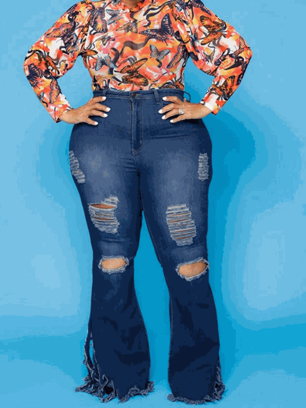 Distressed denim jeans in dark blue with ripped thighs, flared legs and frayed hems, UnWritten Style high-rise fit.
