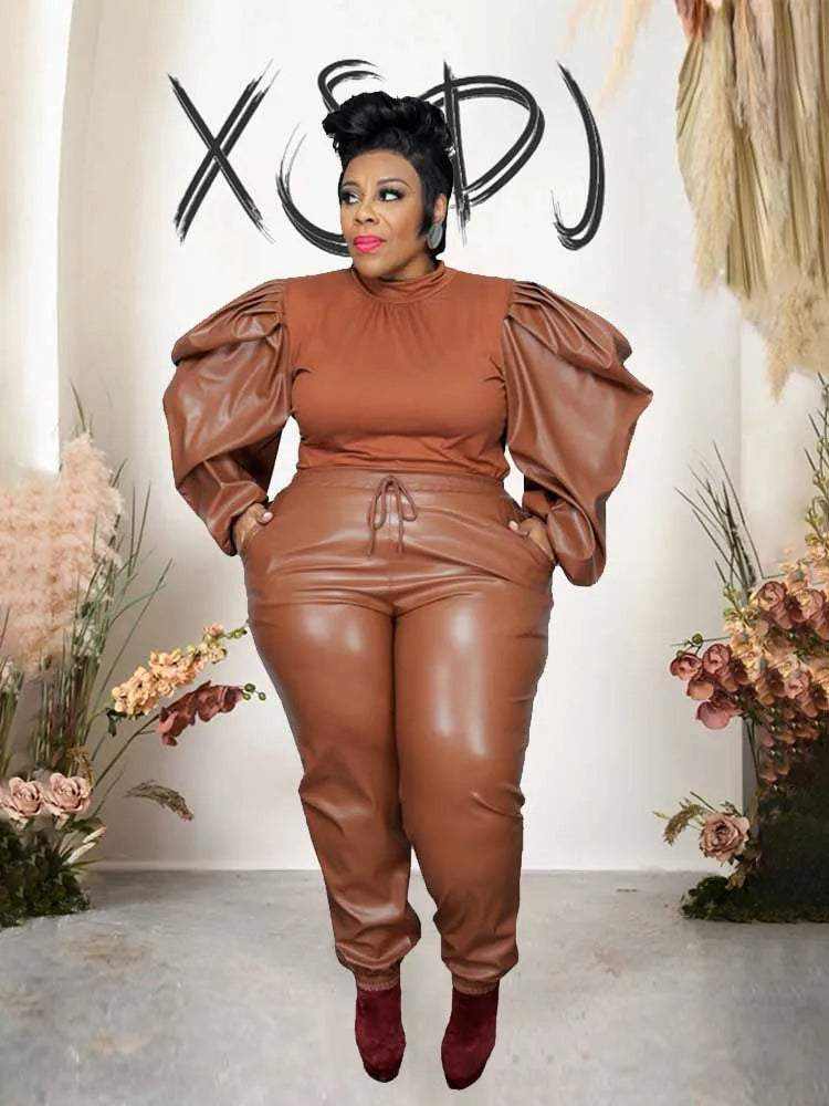 UnWritten Style brown two-piece set with a smooth fitted top, dramatic puff sleeves, and matching faux-leather tapered pants.