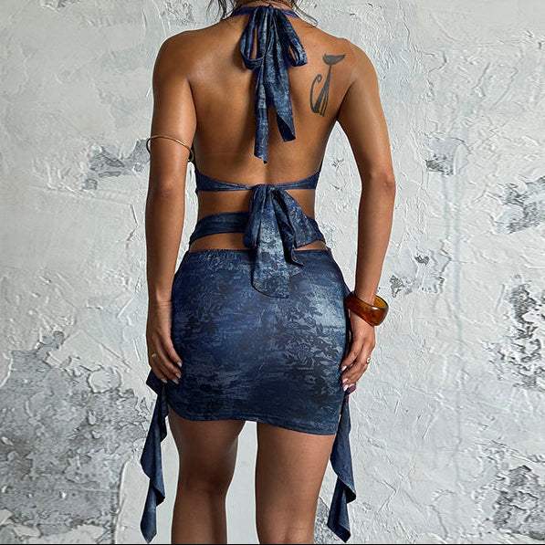 Midnight Muse Cutout Mini Dress in dark blue textured fabric, with an open back, halter ties, waist cutouts and draped accents