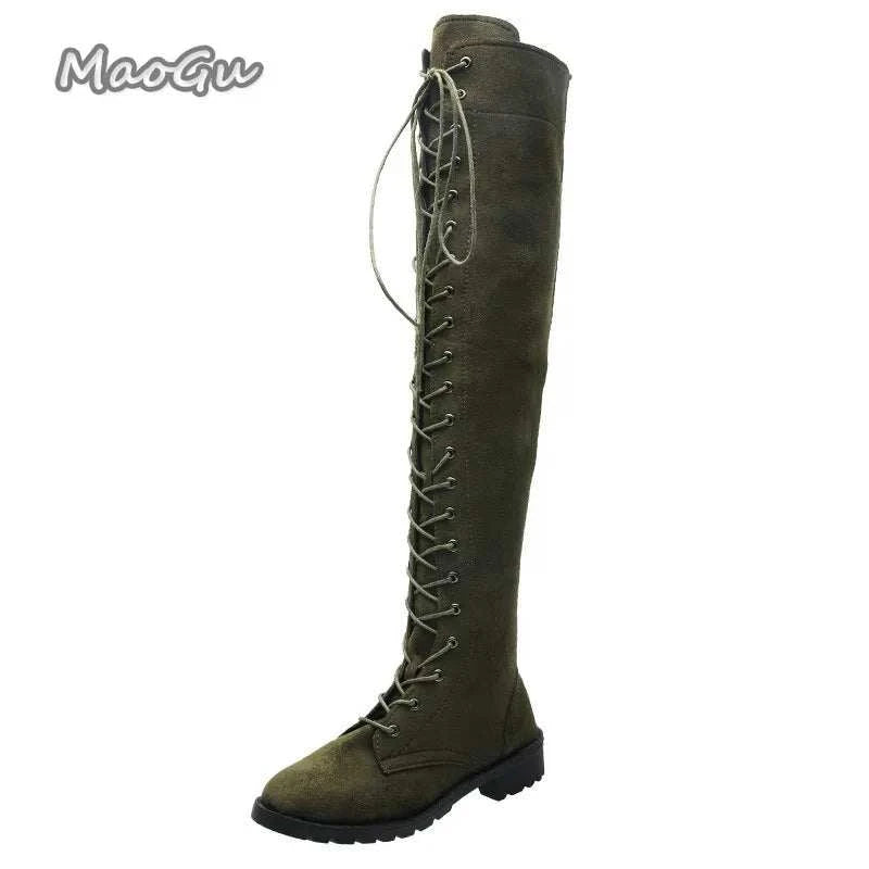 UnWritten Style over-the-knee boot in olive suede-look material with full-length crisscross lacing and a low block heel